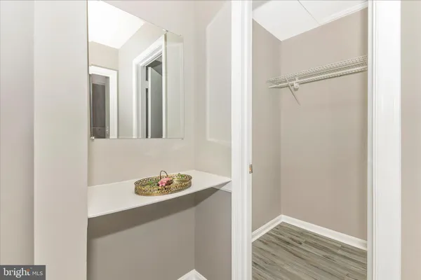 a bathroom with a granite countertop sink and toilet