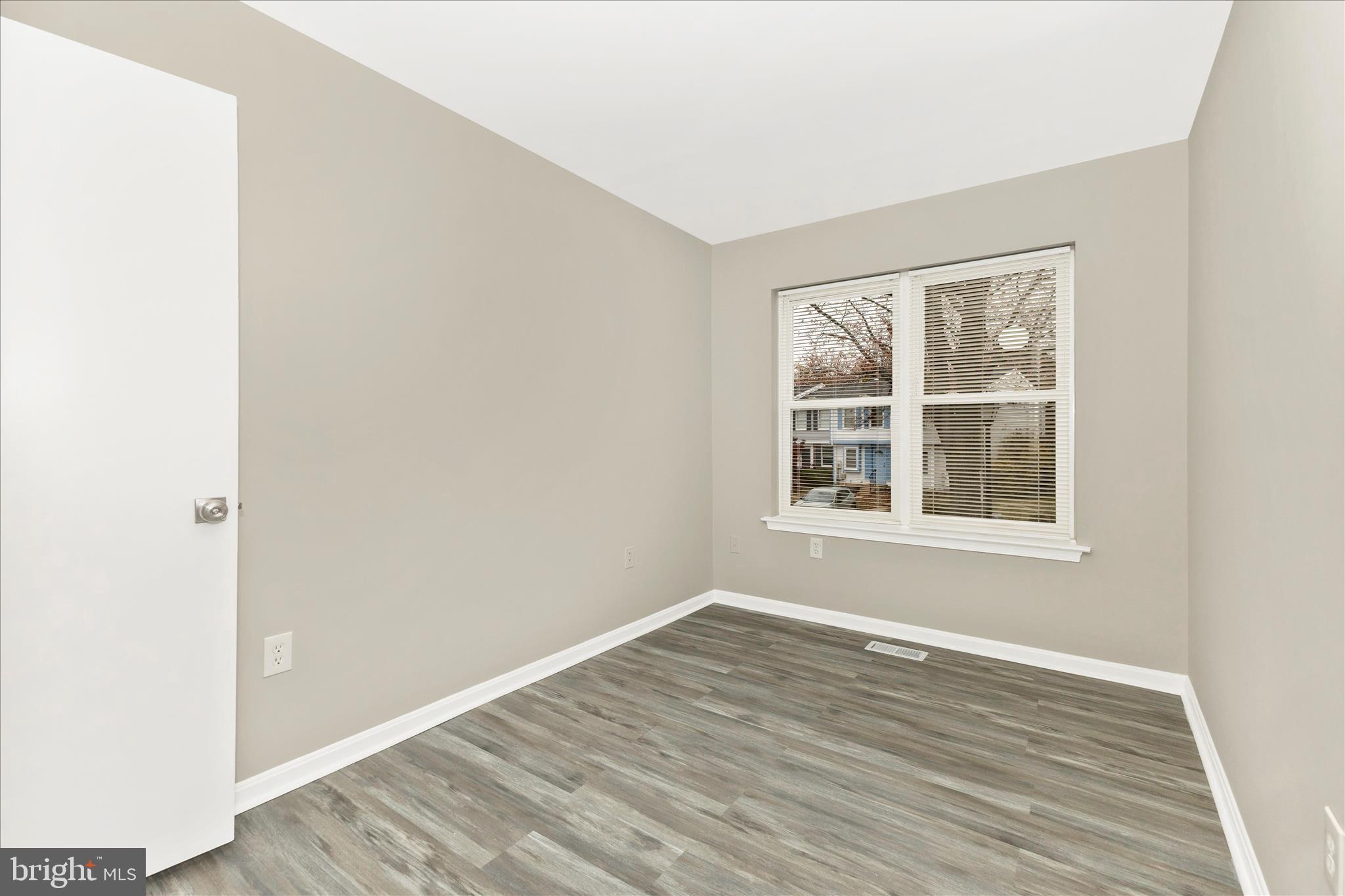 2861 Shepperton Terrace Silver Spring, MD 20904 - Photo 29 of 44 an empty room with wooden floor and windows