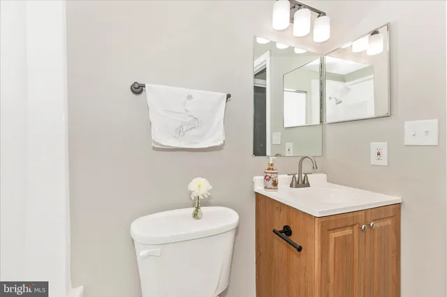 a bathroom with a sink a toilet and mirror