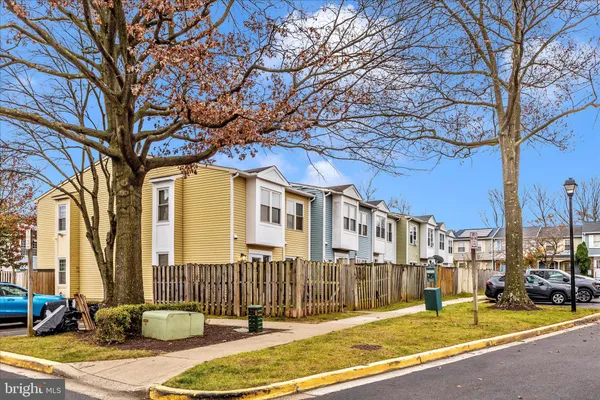 a view of a brick house with a large trees