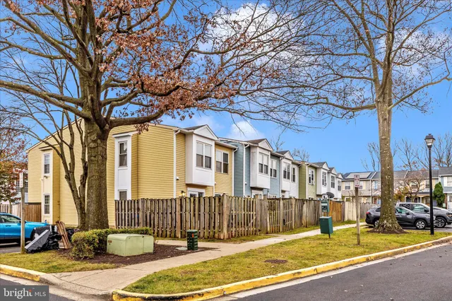 a view of a brick house with a large trees