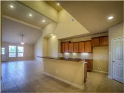 a view of a kitchen with a sink and a refrigerator