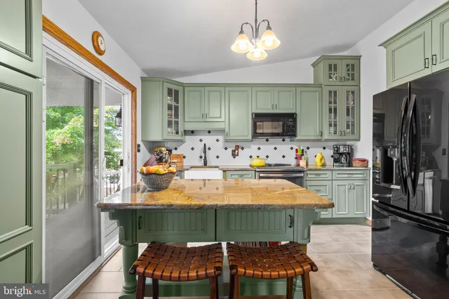 a room with furniture a chandelier and a flat screen tv
