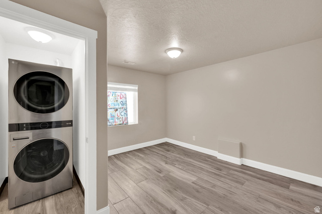 1857 Thunder Gulch Road Eagle Mountain, UT 84005 - Photo 35 of 50 Dedicated laundry area featuring a stacked washer and dryer unit