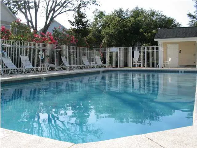 a view of a lake with a yard from a balcony