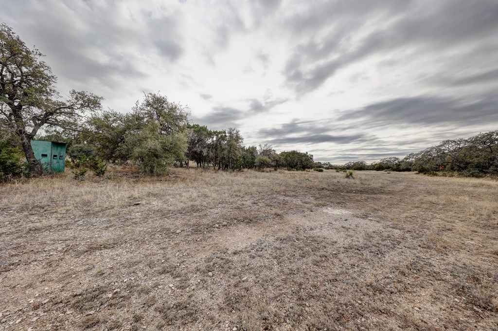 870 Rocky Top Road Southwest Hunt, TX 78024 - Photo 16 of 63 a view of a dry yard with wooden fence