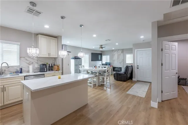 a large kitchen with a large counter top appliances and a sink