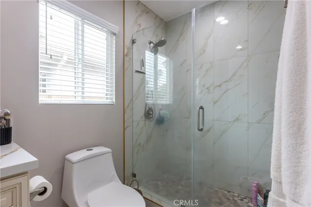 a bathroom with a toilet and a shower