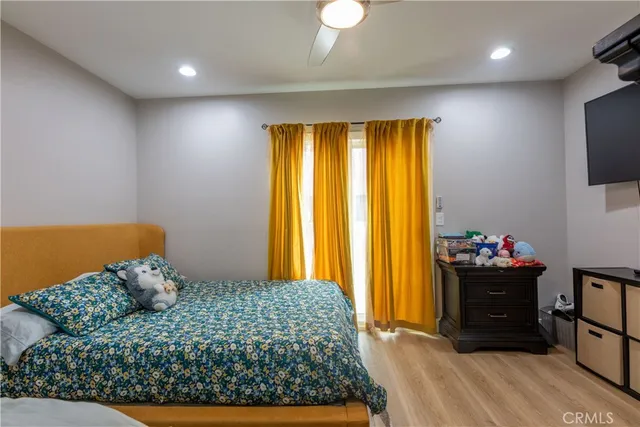 a bedroom with a bed and wooden floor