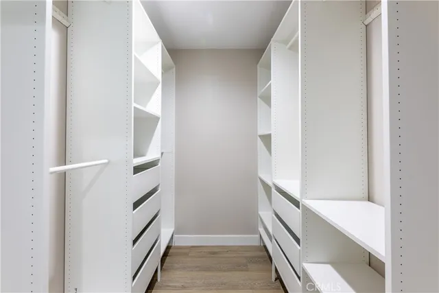 a bathroom with double vanity and a mirror