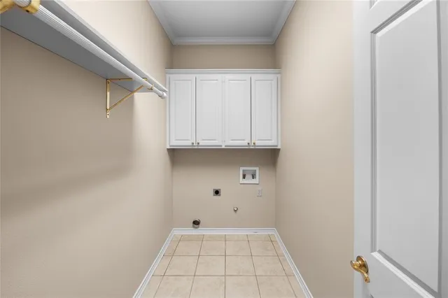 a view of an empty room with white cabinet and a window