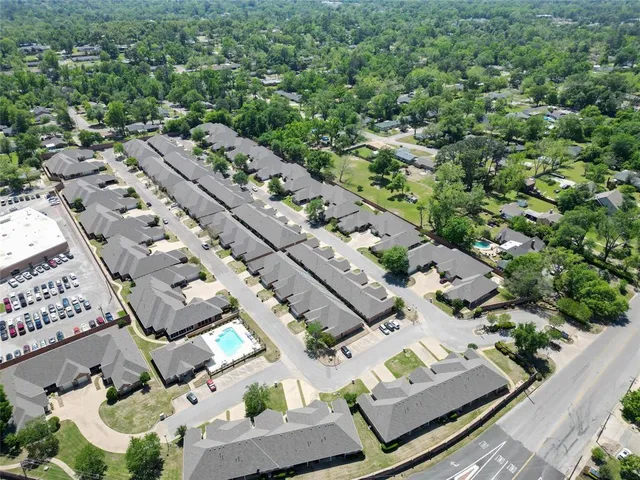 an aerial view of multiple houses with yard