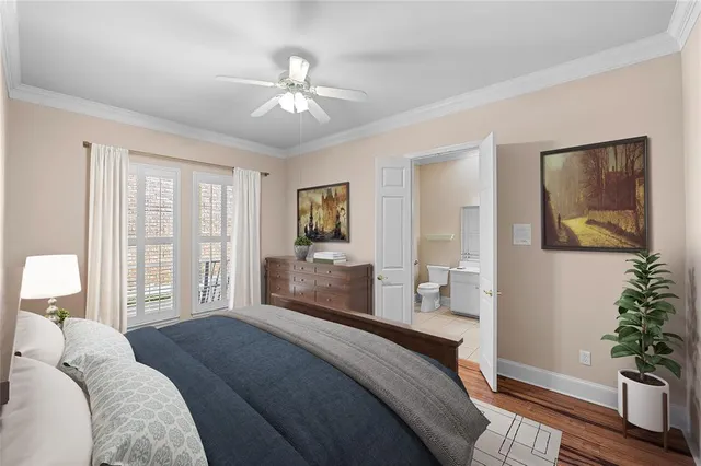 a bedroom with a large bed and a chandelier