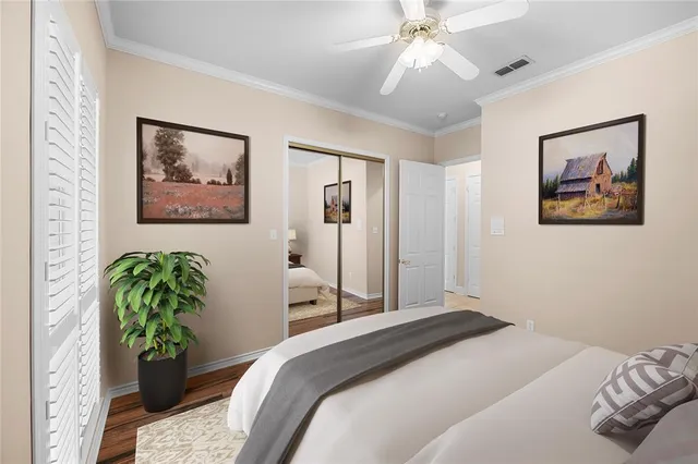 a bedroom with a bed and a painting on the wall