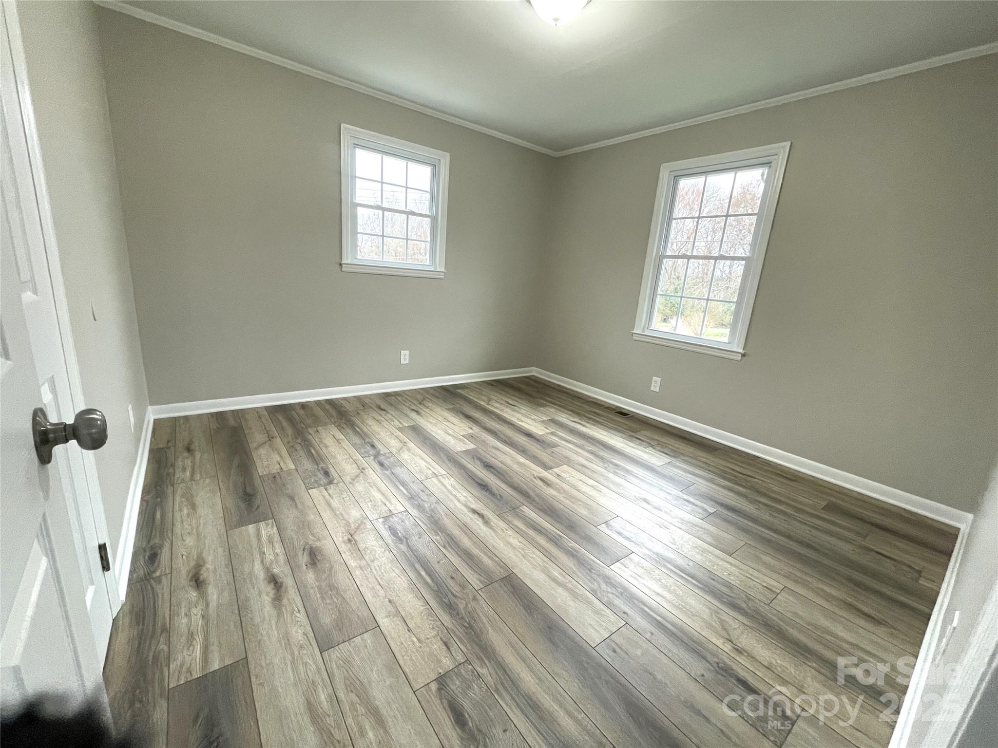 1141 Faile Street Lancaster, SC 29720 - Photo 7 of 18 an empty room with wooden floor and windows