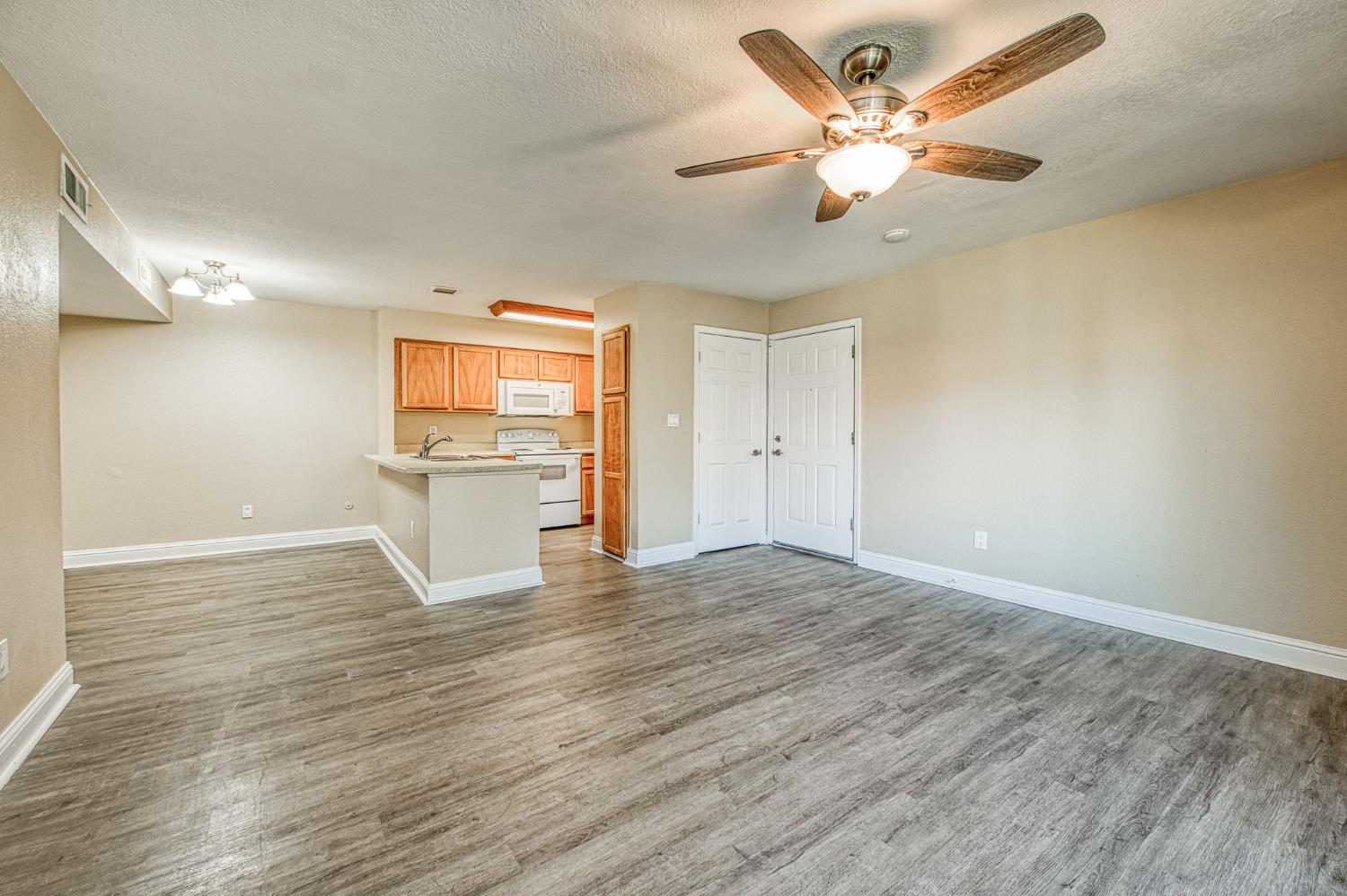 2881 Huntington Boulevard, Unit 262 Fresno, CA 93721 - Photo 13 of 31 wooden floor in an empty room with a window