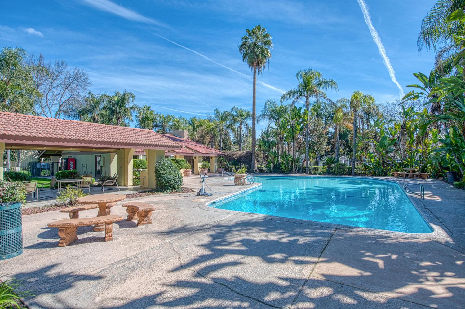 2881 Huntington Boulevard, Unit 262 Fresno, CA 93721 - Photo 2 of 31 a view of a patio with a table and chairs under an umbrella