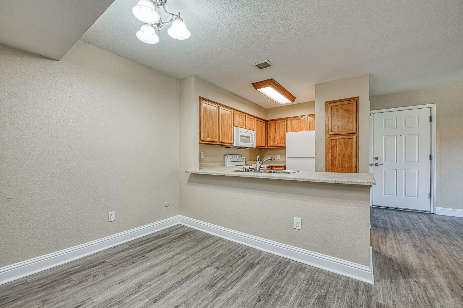 2881 Huntington Boulevard, Unit 262 Fresno, CA 93721 - Photo 21 of 31 wooden floor in an empty room with a window