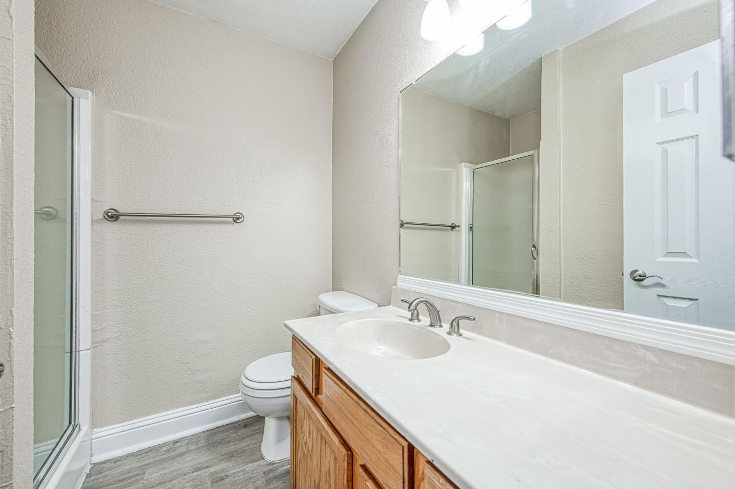 2881 Huntington Boulevard, Unit 262 Fresno, CA 93721 - Photo 22 of 31 a bathroom with a sink a toilet and shower