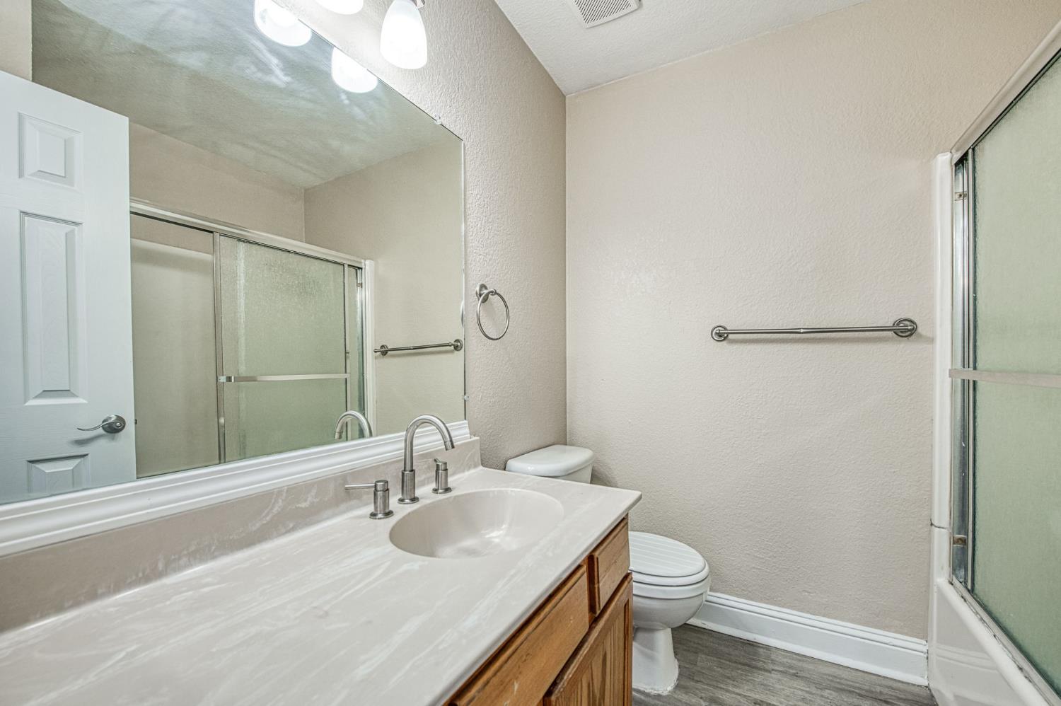 2881 Huntington Boulevard, Unit 262 Fresno, CA 93721 - Photo 28 of 31 a bathroom with a sink toilet and shower