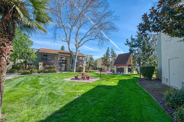 a couple of table and chairs in backyard of house