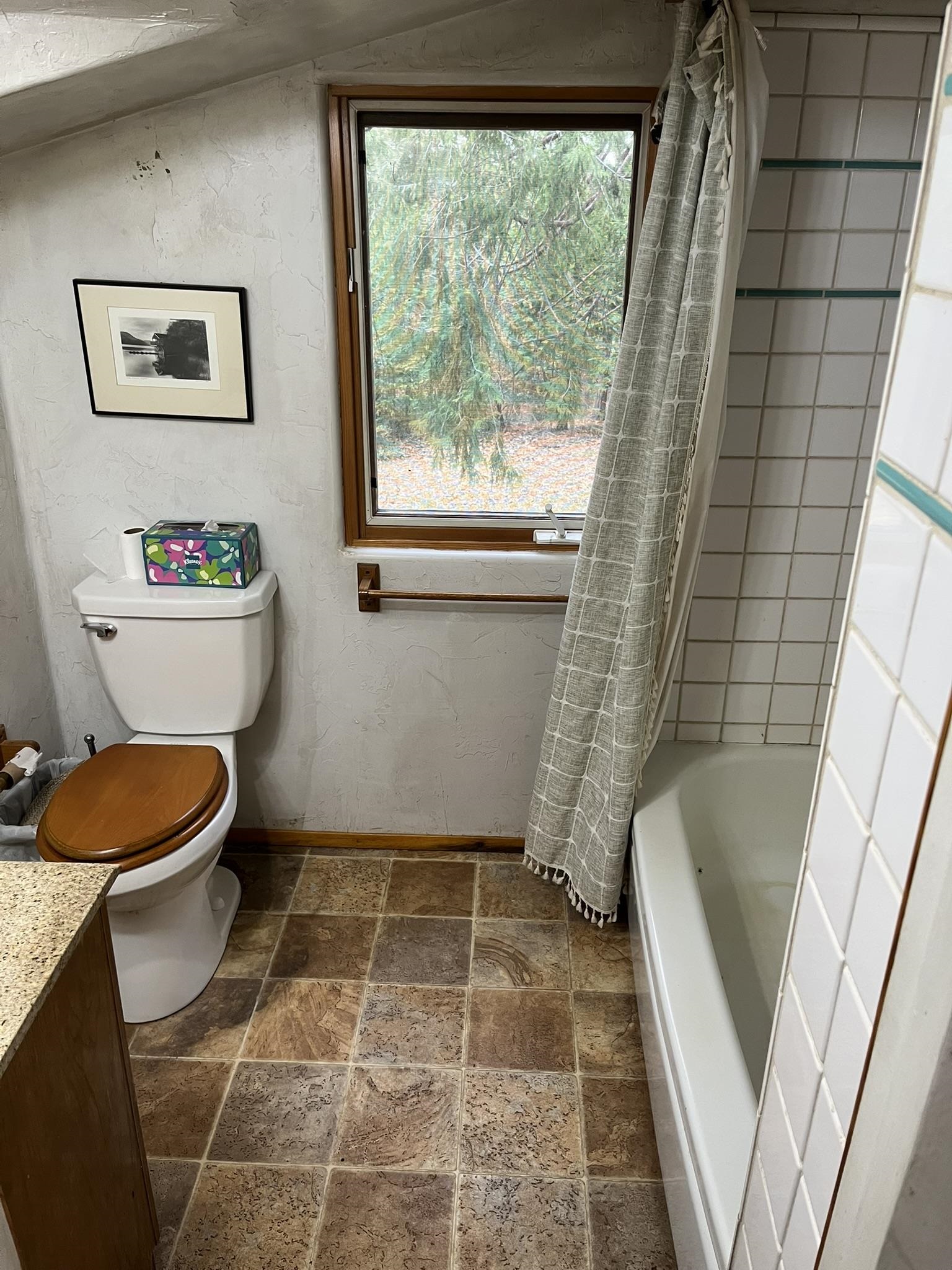 23090 North Bald Mountain Road Sonora, CA 95370 - Photo 15 of 59 Full bathroom featuring stone tile flooring, shower / tub combo with curtain, and vanity