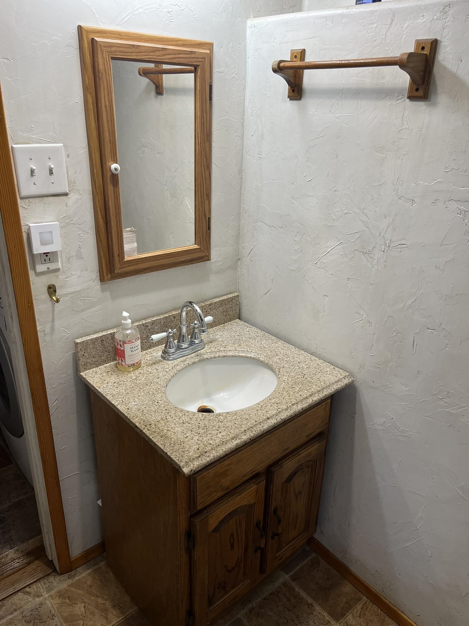 23090 North Bald Mountain Road Sonora, CA 95370 - Photo 17 of 59 Bathroom with a textured wall and vanity