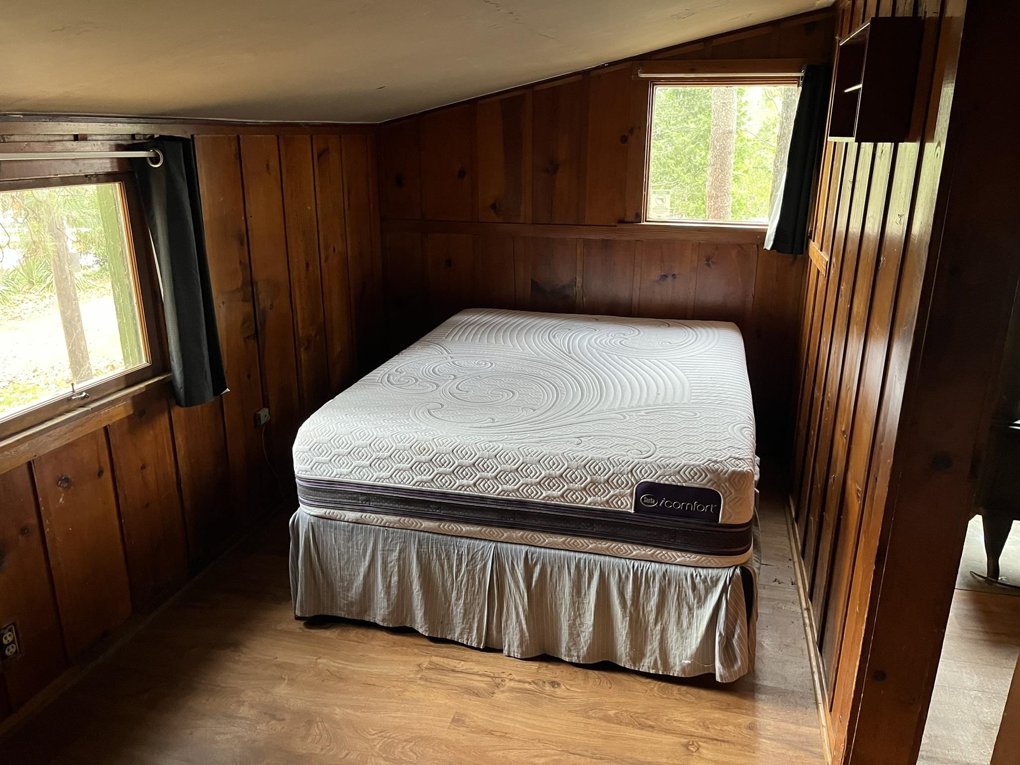 23090 North Bald Mountain Road Sonora, CA 95370 - Photo 29 of 59 Bedroom with wooden walls, lofted ceiling, and light wood-type flooring