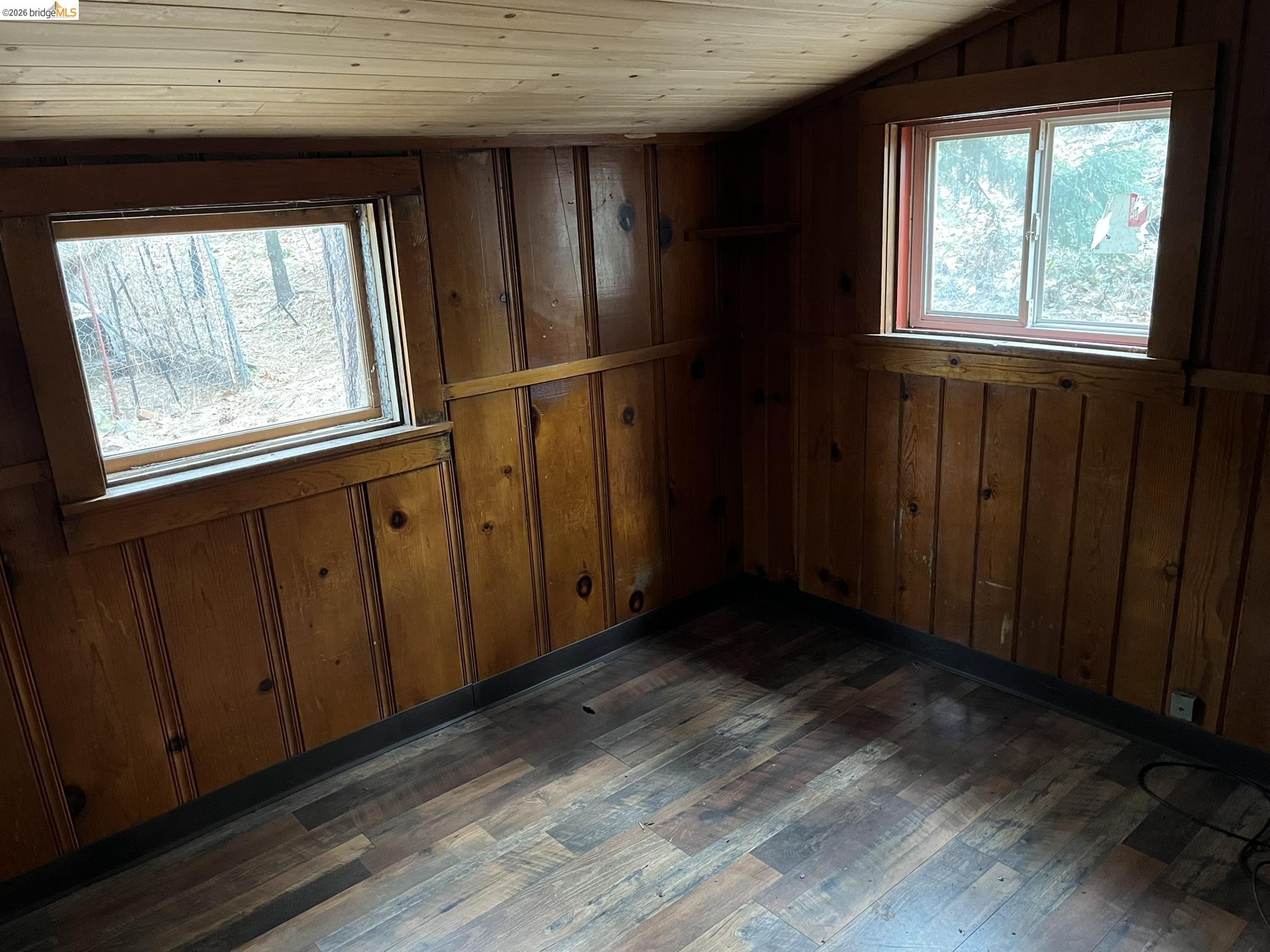 23090 North Bald Mountain Road Sonora, CA 95370 - Photo 45 of 59 a view of an empty room with wooden floor and a window