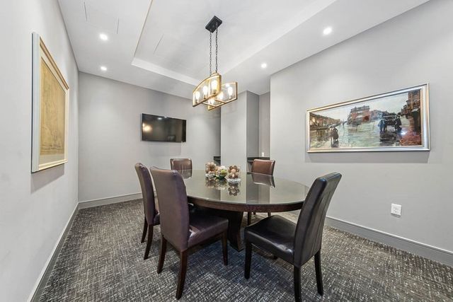 a view of a dining room with furniture and a chandelier