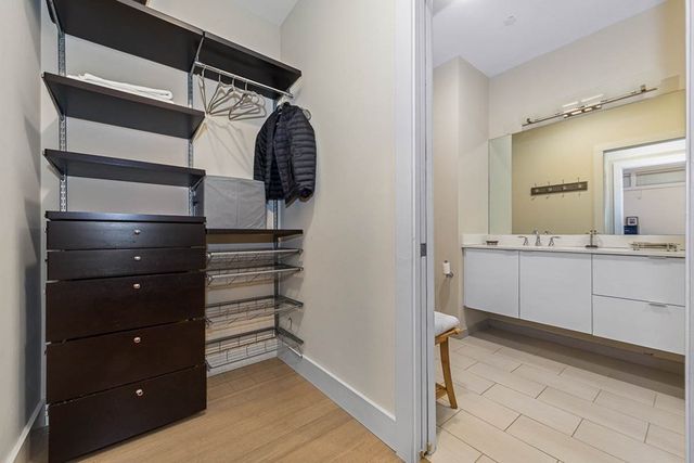 a view of walk in closet and bedroom