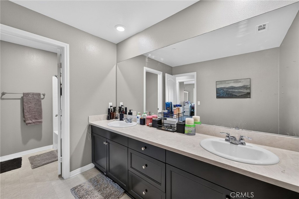 23347 Crystal Way Wildomar, CA 92595 - Photo 63 of 109 a bathroom with double vanity sinks double vanity and a shower