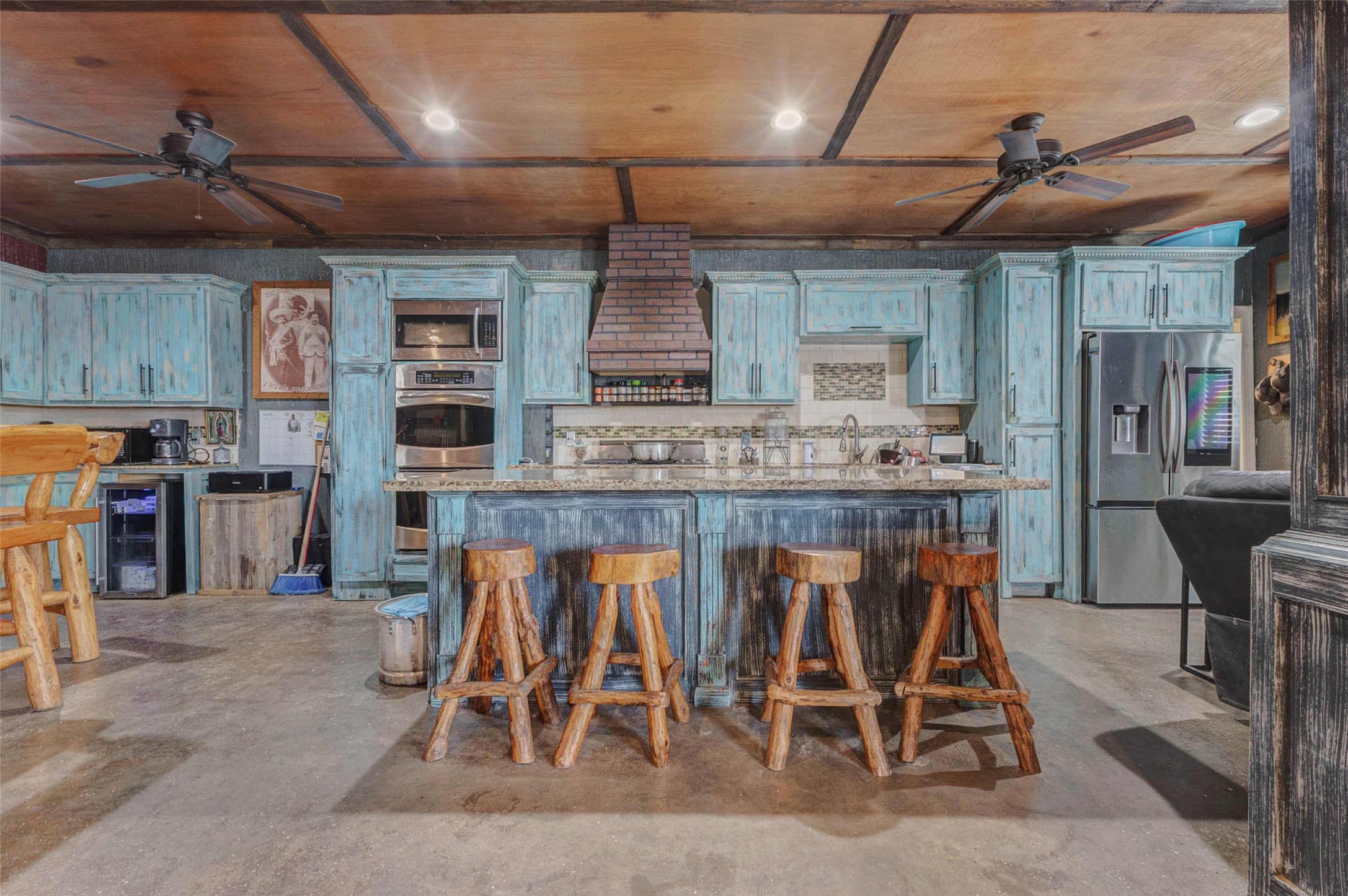 4008 Colvin Street Houston, TX 77013 - Photo 12 of 28 a kitchen with stainless steel appliances granite countertop table chairs sink and cabinets