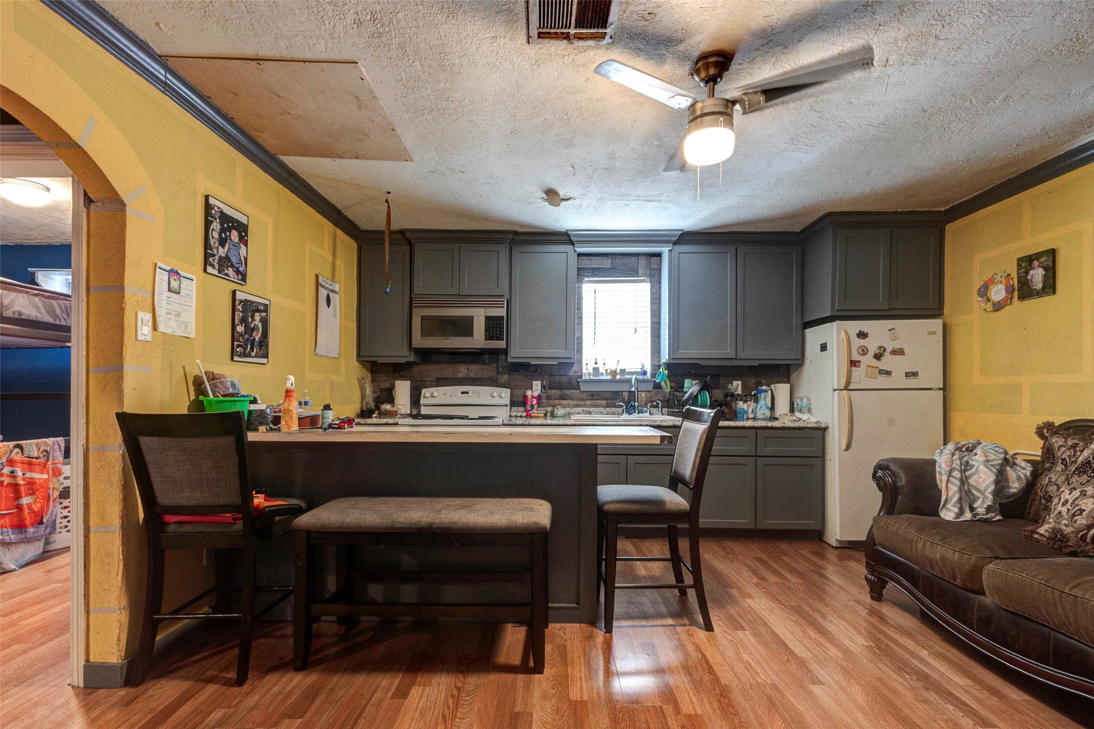 4008 Colvin Street Houston, TX 77013 - Photo 21 of 28 a kitchen with a dining table chairs refrigerator and cabinets