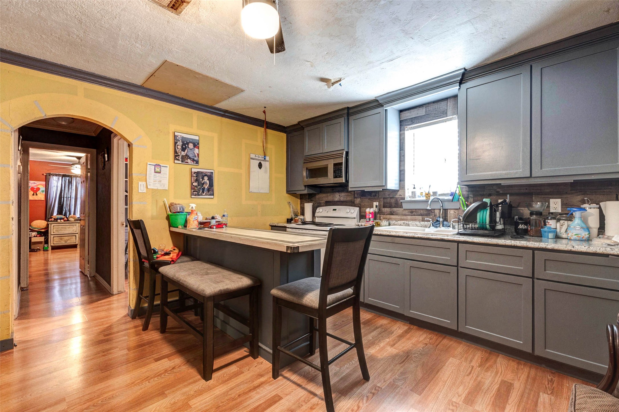 4008 Colvin Street Houston, TX 77013 - Photo 22 of 28 a kitchen with a table chairs sink and cabinets