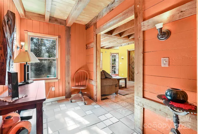 a large bedroom with a large bed and a chandelier