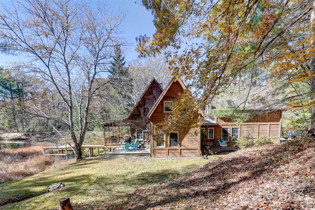 a view of a house with a yard covered in snow