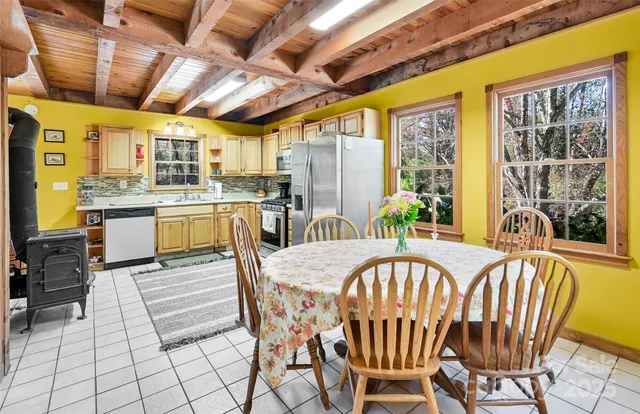 a dining room with furniture a chandelier and wooden floor