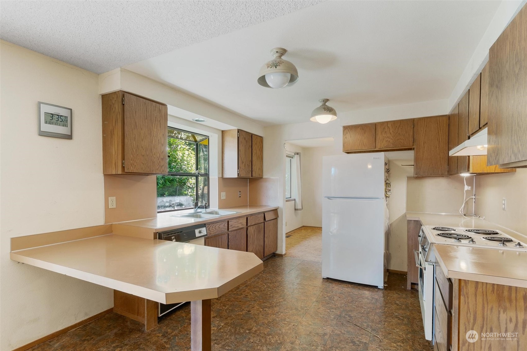 13223 Vail Cut Off Road Southeast Rainier, WA 98576 - Photo 8 of 32 a kitchen with stainless steel appliances granite countertop a sink a stove a refrigerator cabinets and a dining table