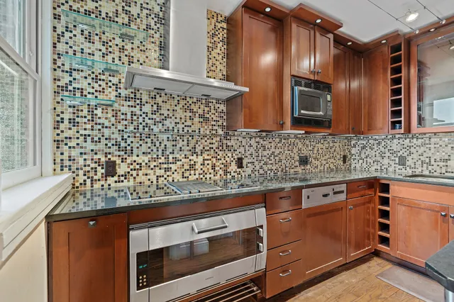 a view of a kitchen with cabinets and wooden floor
