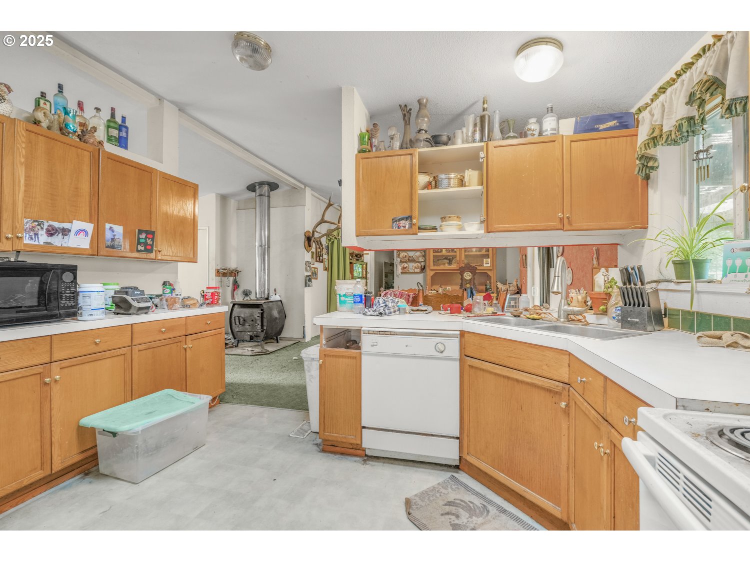 19807 Highway 211 Colton, OR 97017 - Photo 8 of 22 a kitchen with cabinets a sink and appliances