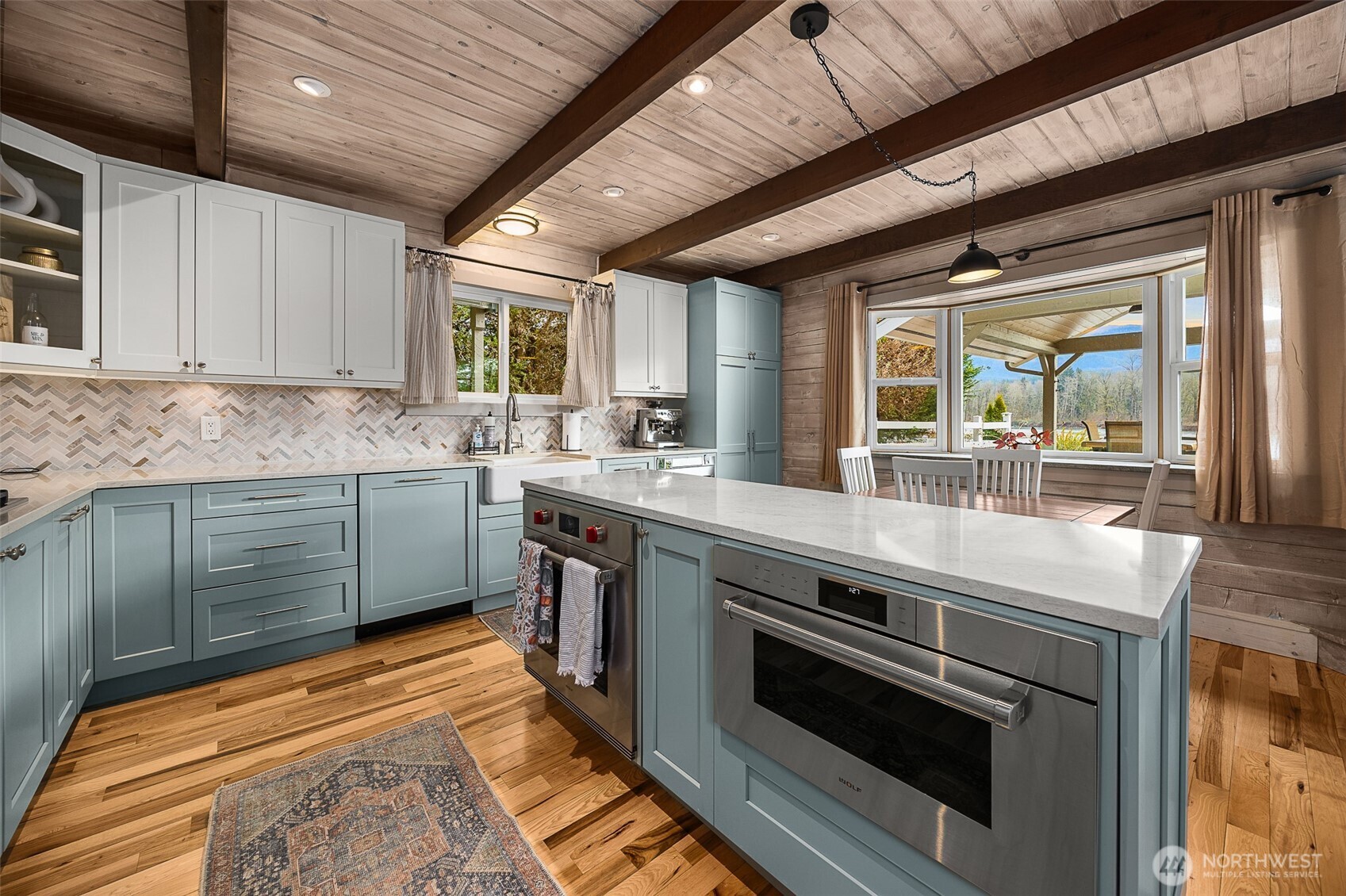 1122 Dyer Road Sultan, WA 98294 - Photo 13 of 40 a kitchen with stainless steel appliances granite countertop a sink a stove and a wooden floors