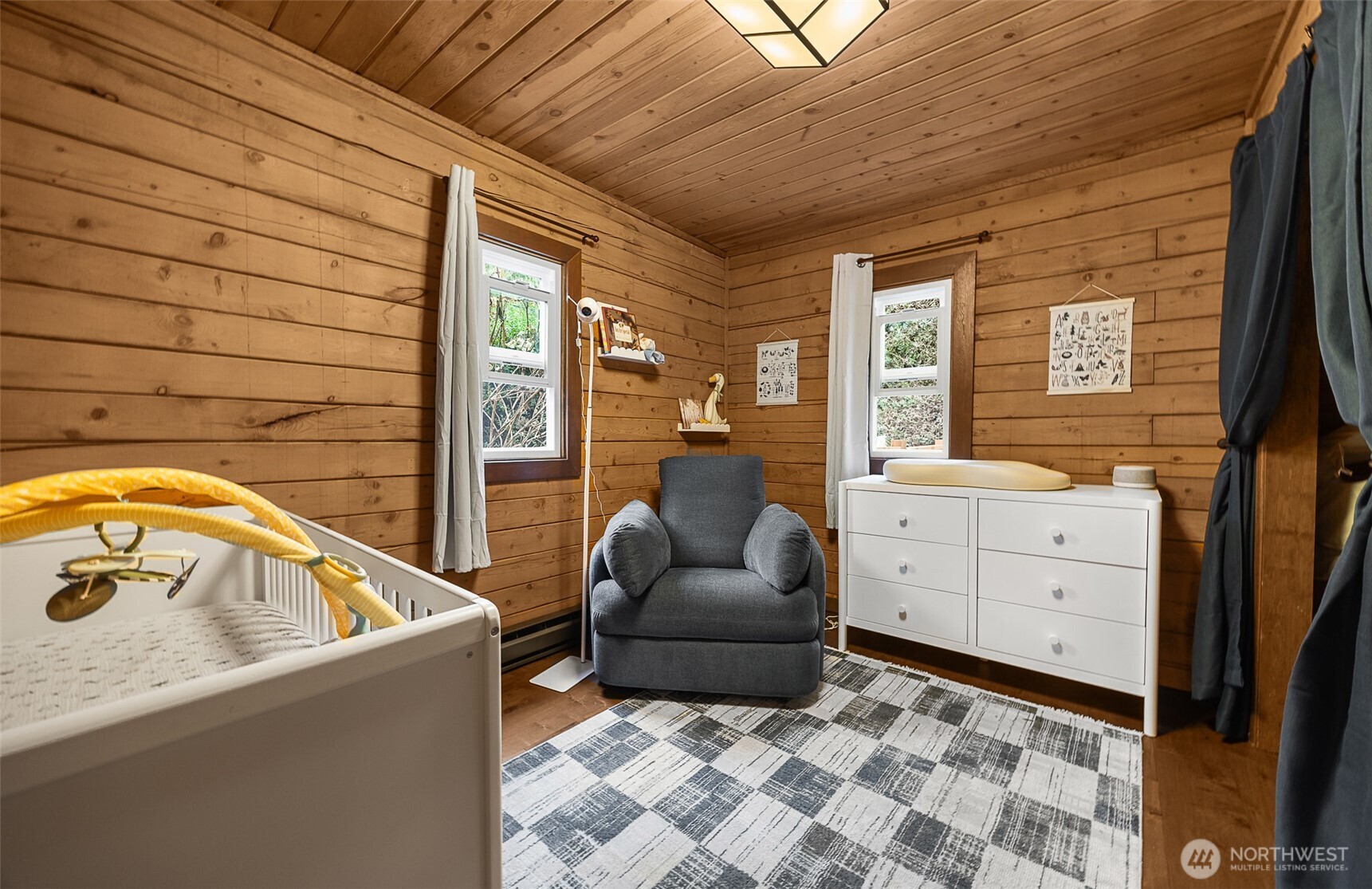 1122 Dyer Road Sultan, WA 98294 - Photo 15 of 40 a living room with a couch and dresser with wooden floor