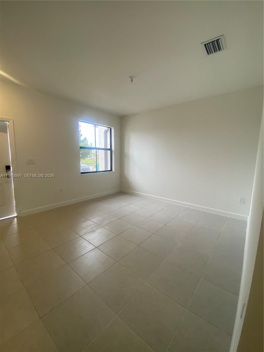 12773 Southwest 234th Terrace Homestead, FL 33032 - Photo 4 of 11 an empty room with windows