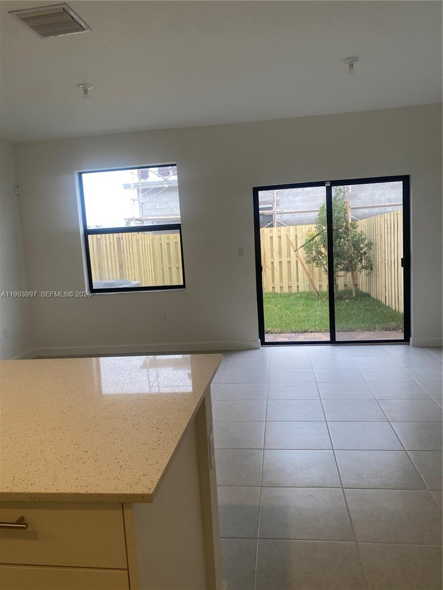 12773 Southwest 234th Terrace Homestead, FL 33032 - Photo 5 of 11 a view of an empty room with a window