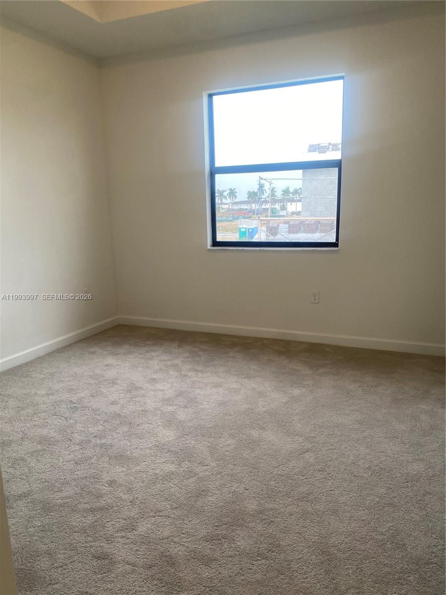 12773 Southwest 234th Terrace Homestead, FL 33032 - Photo 7 of 11 an empty room with a window