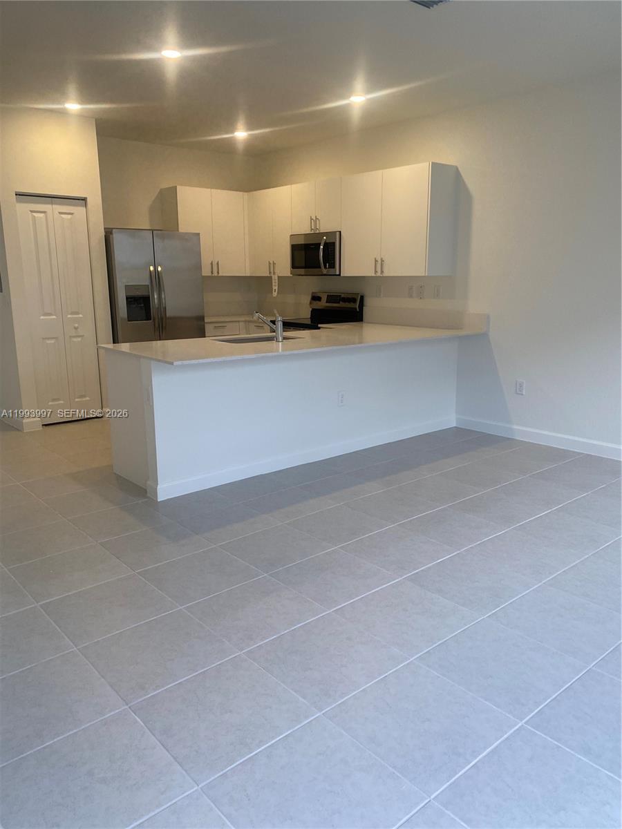 12773 Southwest 234th Terrace Homestead, FL 33032 - Photo 9 of 11 a large kitchen with a lot of counter space and stainless steel appliances