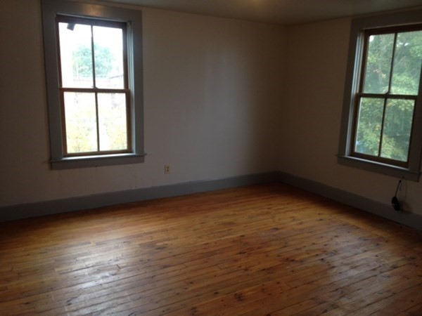 30 3rd Street Montague, MA 01376 - Photo 15 of 15 an empty room with wooden floor and windows