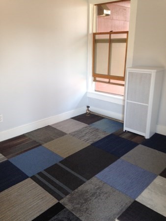 30 3rd Street Montague, MA 01376 - Photo 9 of 15 an empty room with wooden floor and windows