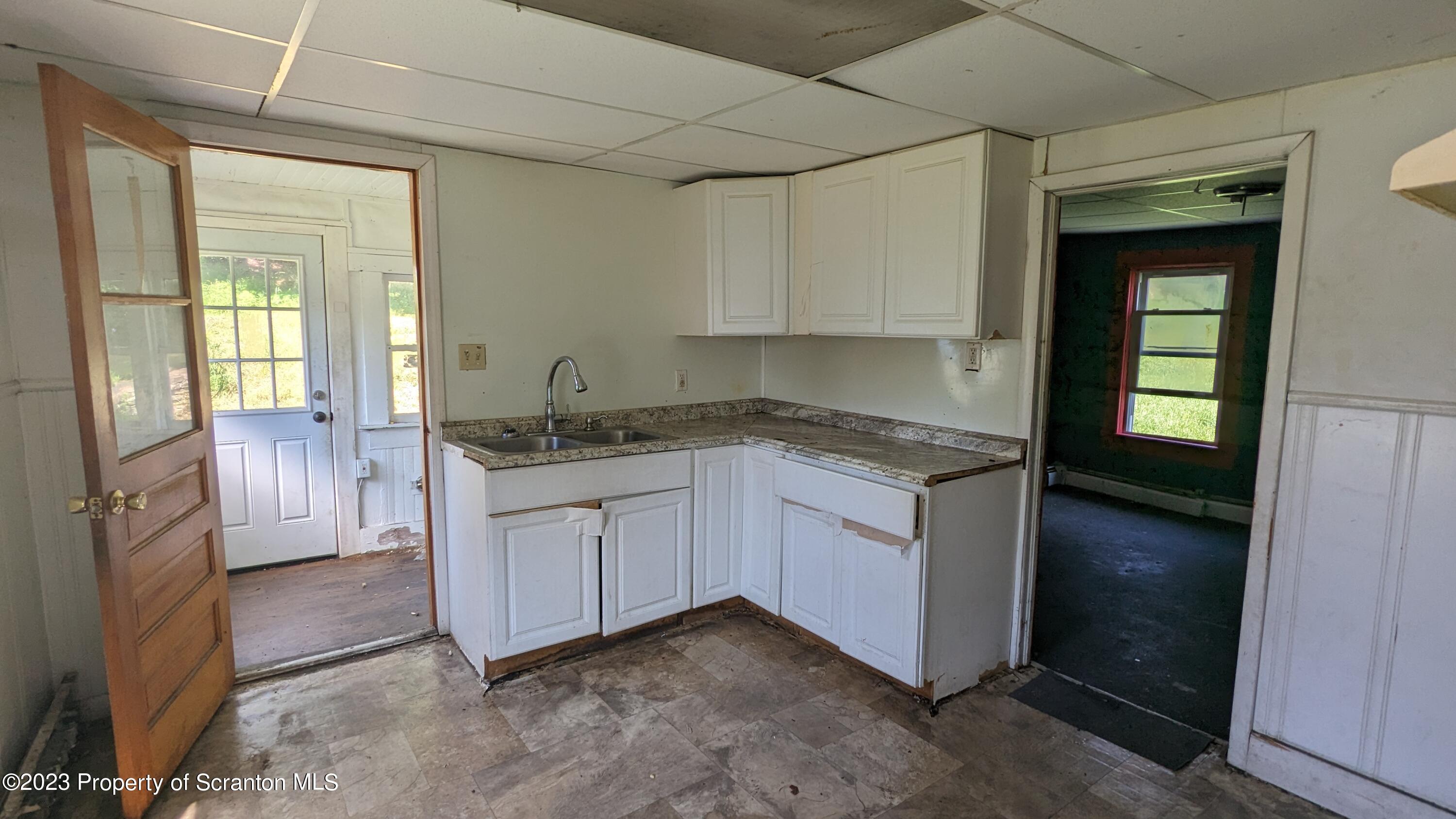 357 Hughes Court Scranton, PA 18504 - Photo 9 of 16 a kitchen with granite countertop a sink and cabinets